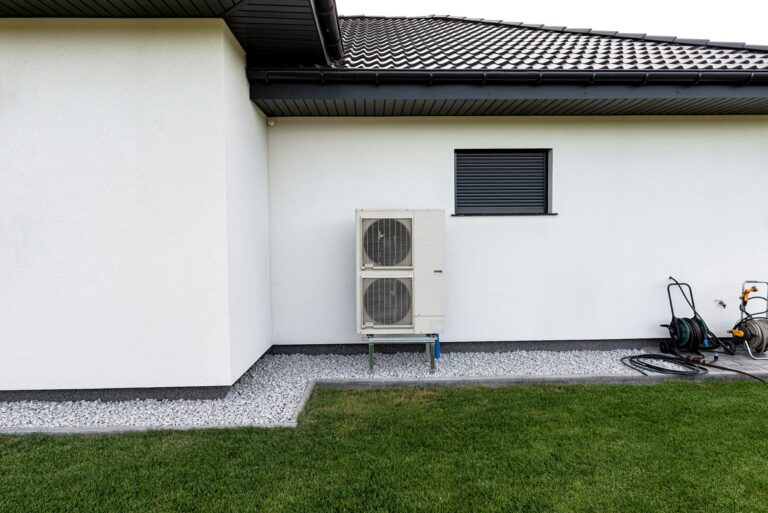 Two efficient outdoor heat pump units placed in front of the house.