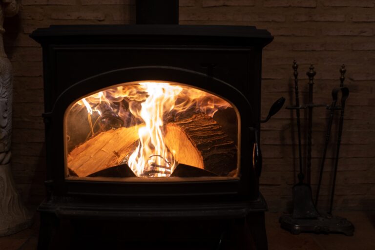 A charcoal burner is getting warmer with the firewood burning inside